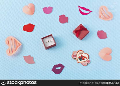 Hearts and ring on a blue background. Valentine’s Day. Valentines day greeting card. An offer of marriage. Engagement. Lips. Flatly.. Hearts and ring on a blue background. Valentine’s Day. Valentines day greeting card. An offer of marriage. Engagement. Lips. Flatly