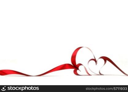 Hearts from red ribbon isolated on white background