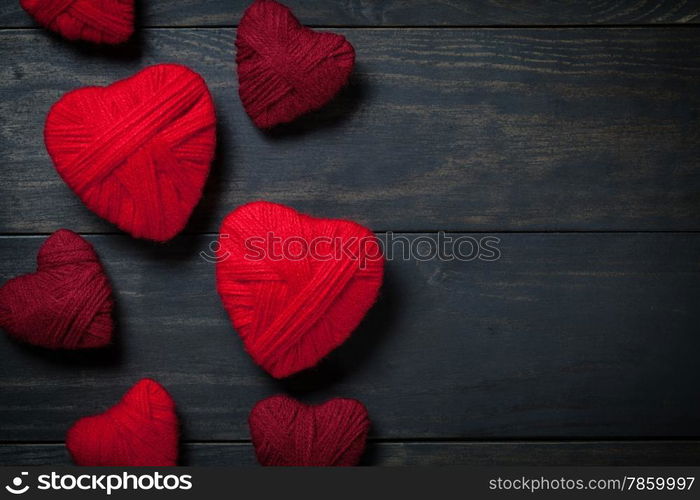 Hearts made of red wool on wooden background for Valentine&rsquo;s Day. Copy space. Top view