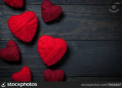 Hearts made of red wool on wooden background for Valentine&rsquo;s Day. Copy space. Top view