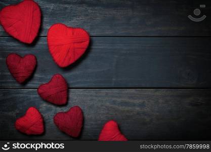 Hearts made of red wool on wooden background for Valentine&rsquo;s Day. Copy space. Top view