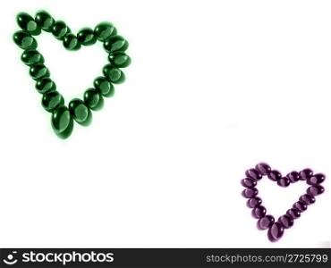 Hearts of geen adn purple beads on a white background