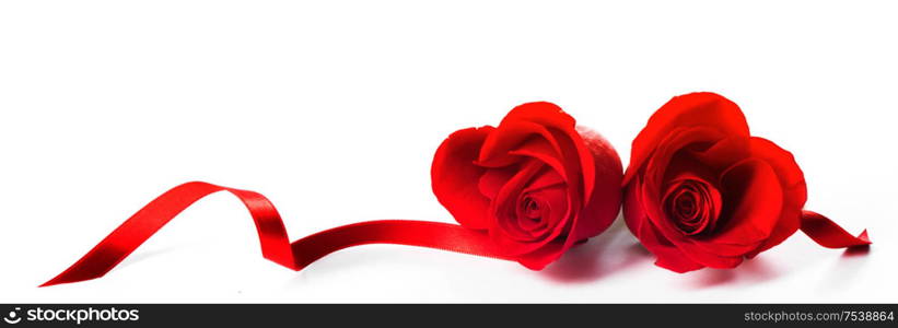 Hearts of red roses and curly ribbons isolated on white background Valentines day design. Hearts of res roses