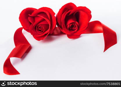 Hearts of red roses and curly ribbons isolated on white background Valentines day design. Hearts of res roses