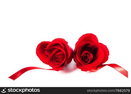 Hearts of red roses and curly ribbons isolated on white background Valentines day design. Hearts of res roses