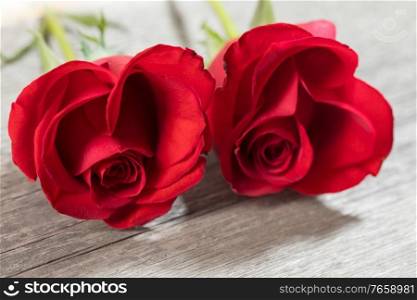 Hearts of red roses on wooden background Valentines day design. Hearts of red roses