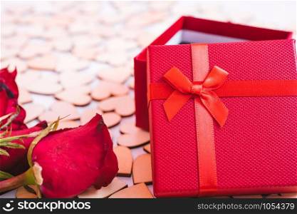 Hearts on white wooden background have a gift box and flower rose, valentine day concept