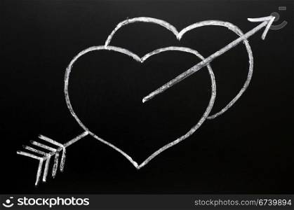 Hearts with Cupid&rsquo;s arrow hitting through, drawn in chalk