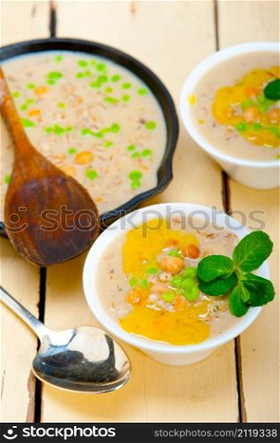 Hearty Middle Eastern Chickpea and Barley Soup with mint leaves on top
