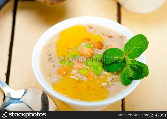 Hearty Middle Eastern Chickpea and Barley Soup with mint leaves on top