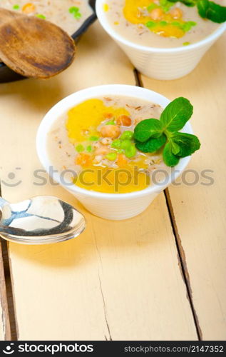 Hearty Middle Eastern Chickpea and Barley Soup with mint leaves on top