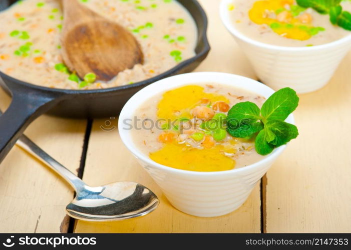 Hearty Middle Eastern Chickpea and Barley Soup with mint leaves on top