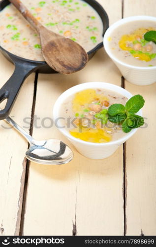 Hearty Middle Eastern Chickpea and Barley Soup with mint leaves on top