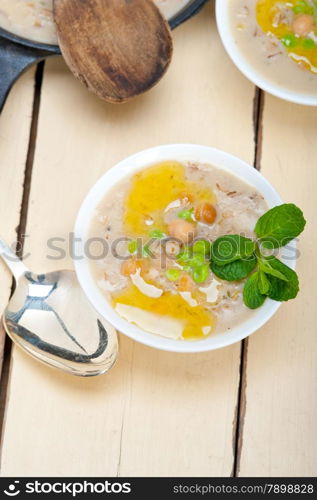 Hearty Middle Eastern Chickpea and Barley Soup with mint leaves on top