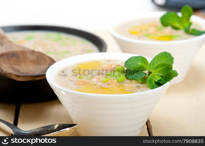 Hearty Middle Eastern Chickpea and Barley Soup with mint leaves on top