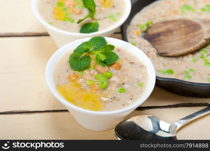 Hearty Middle Eastern Chickpea and Barley Soup with mint leaves on top