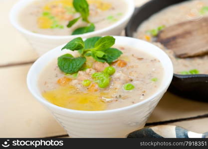 Hearty Middle Eastern Chickpea and Barley Soup with mint leaves on top