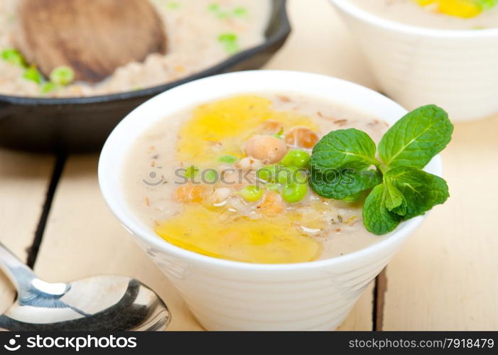 Hearty Middle Eastern Chickpea and Barley Soup with mint leaves on top