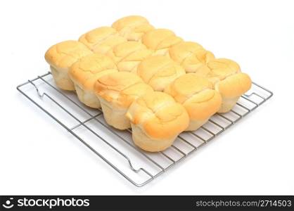 Heat And Serve Biscuits. Sore bought heat and serve biscuits on a chrome plated cooling rack on a white background