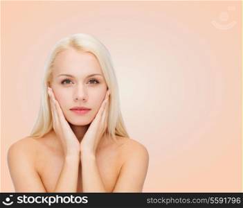 heath and beauty concept - beautiful woman touching her face skin