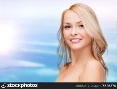 heath and beauty concept - closeup of clean face and shoulders of beautiful young woman