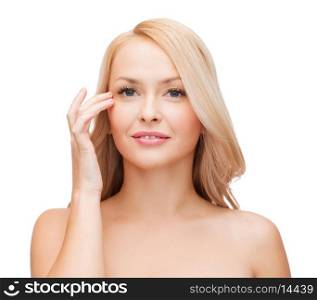 heath and beauty concept - face of beautiful woman touching her eye area