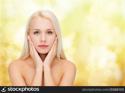 heath and beauty concept - face of beautiful woman touching her face skin
