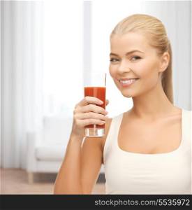 heath and diet concept - young woman holding glass of tomato juice