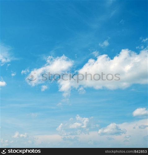 Heavenly background - white fluffy clouds in bright blue sky.