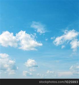 Heavenly landscape - white clouds in bright blue sky.