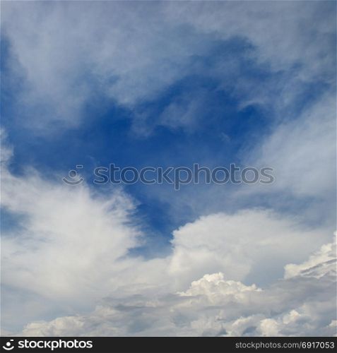 Heavenly seascape. White clouds on a background of blue sky.