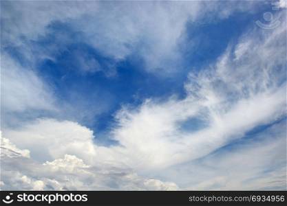 Heavenly seascape. White clouds on a background of dark blue sky.
