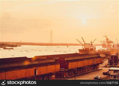 heavy crane tool in ship port and contain stock at sunset scene