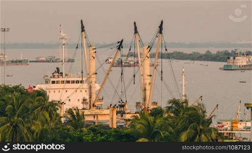 Heavy crane tool in ship port and contain stock at sunset scene