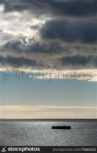 Heavy dark clouds over the winter sea in Odessa, Ukraine. Clouds over the winter sea