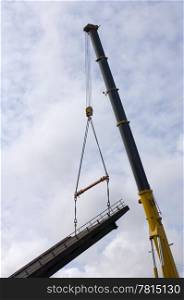 Heavy equipment and cranes in action during the maintenance of a motorway bridge, where entire bridge parts were replaced