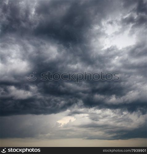 heavy low storm clouds in evening spring sky