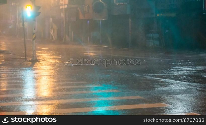 Heavy rain pouring on city street during typhoon Souledor