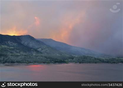 heavy smoke from High Park wildfire obscuring the sun and sky over Horsetooth Reservoir and foothills near Fort Collins, Colorado