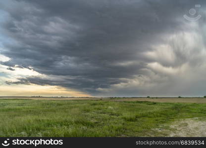 heavy storm clouds and rain over Nebraska farmland in spring