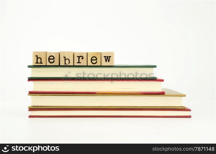 hebrew word on wood stamps stack on books, foreign language and translation concept