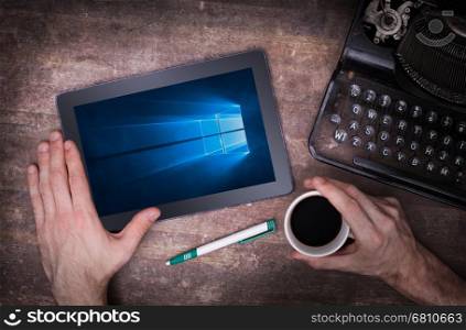 HEERENVEEN, NETHERLANDS, June 6, 2015: Tablet computer with Windows 10 background. Windows 10 is the new version of Windows OS by Microsoft Corporation; it starting July 29, 2015.