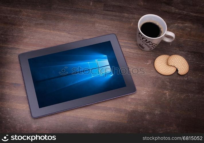 HEERENVEEN, NETHERLANDS, June 6, 2015: Tablet computer with Windows 10 background. Windows 10 is the new version of Windows OS by Microsoft Corporation; it starting July 29, 2015.