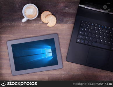 HEERENVEEN, NETHERLANDS, June 6, 2015: Tablet computer with Windows 10 background. Windows 10 is the new version of Windows OS by Microsoft Corporation; it starting July 29, 2015.