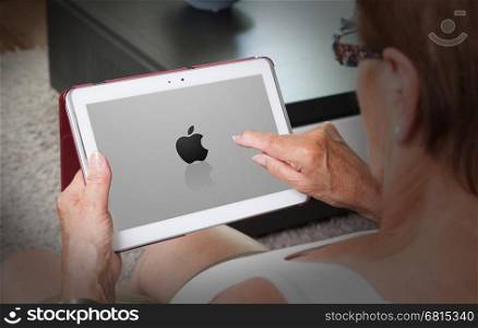 Heerenveen, the Netherlands - July 6, 2015: Black Apple logo is displayed on a white iPad on July 6, 2015 in Heerenveen