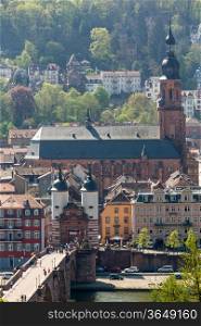 HEIDELBERG, GERMANY - APRIL 25: Tourists and locals stroll through gateway into old town on 25 April 2013. The bridge was built in 1786
