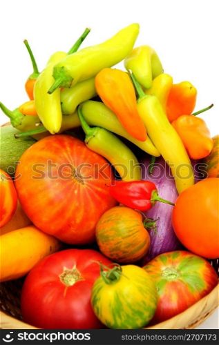Heirloom tomato and hot chili peppers on a white background.. Hot Chilis And Tomatoes