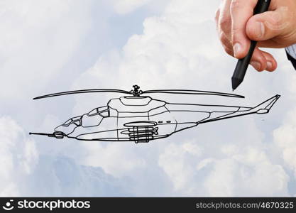 Helicopter design. Person hand drawing helicopter model ob sky background