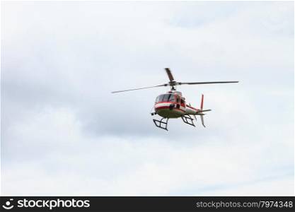 Helicopter flying against the blue sky background