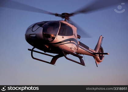 Helicopter flying in the blue sky